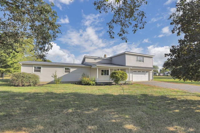 view of front of property featuring a garage and a front lawn