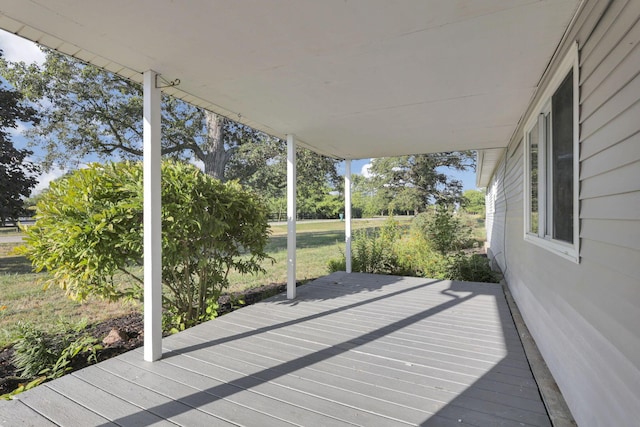 wooden terrace with a lawn