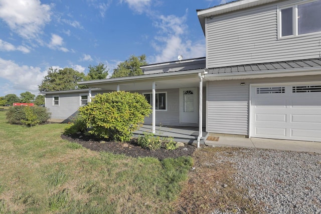 view of front facade with a porch, a garage, and a front yard