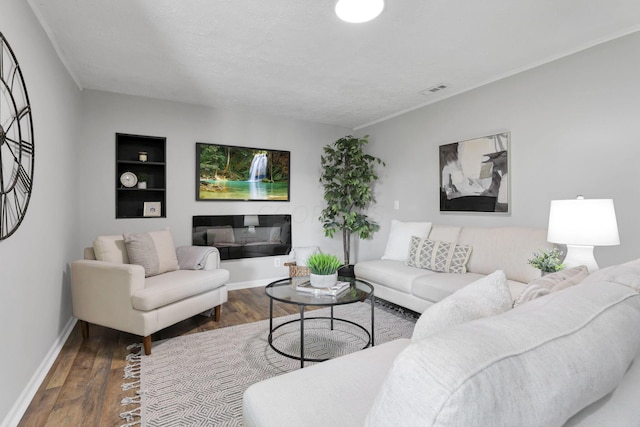 living room with a textured ceiling and dark hardwood / wood-style floors