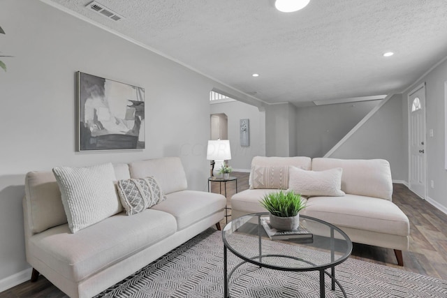 living room with a textured ceiling and hardwood / wood-style flooring