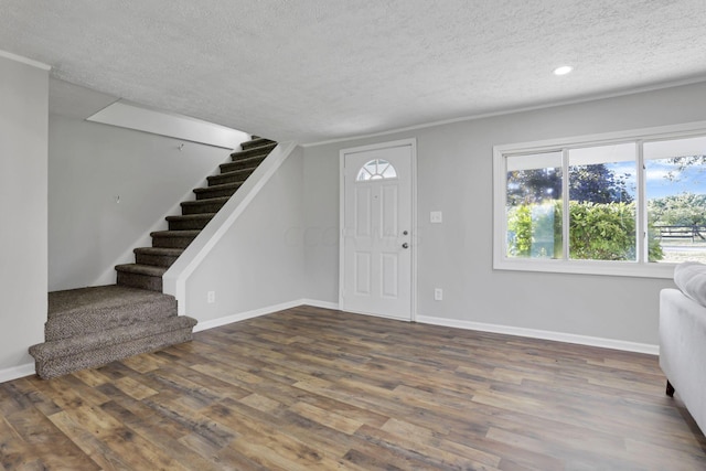 entrance foyer featuring dark hardwood / wood-style flooring and a textured ceiling