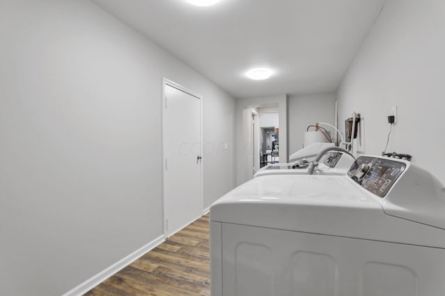 laundry room featuring dark hardwood / wood-style floors and washing machine and clothes dryer