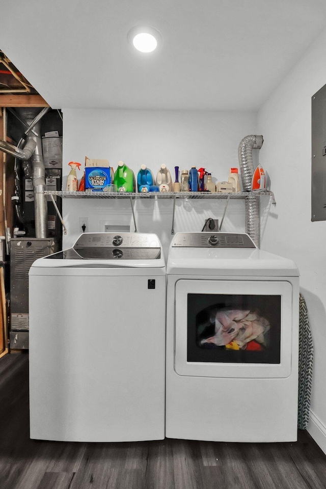 clothes washing area with dark hardwood / wood-style flooring and washing machine and clothes dryer