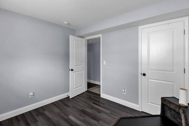 unfurnished bedroom featuring dark hardwood / wood-style floors