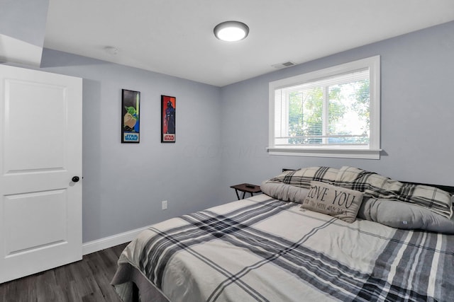 bedroom featuring dark hardwood / wood-style flooring