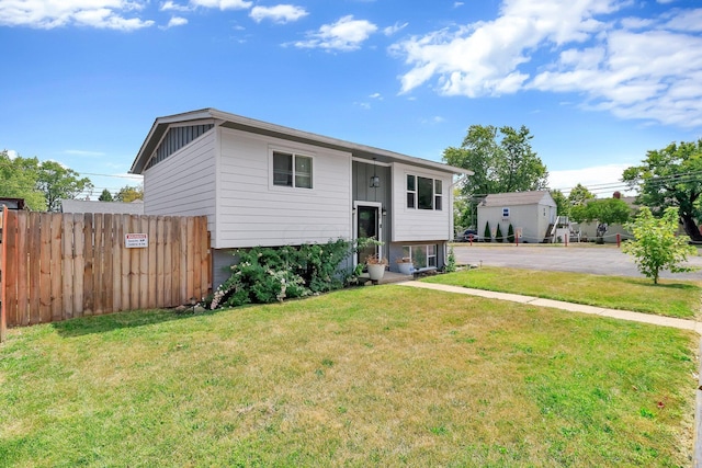 bi-level home with a front lawn