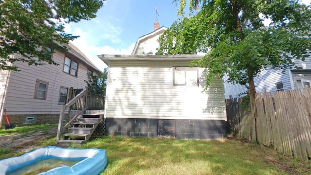 rear view of property with a yard