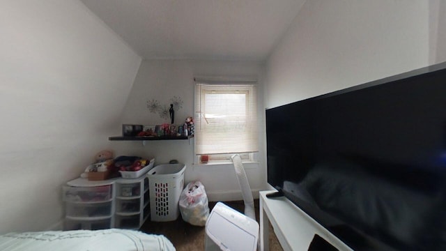 bedroom featuring dark hardwood / wood-style floors and vaulted ceiling