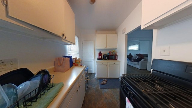 kitchen featuring electric range, white cabinets, and dark wood-type flooring