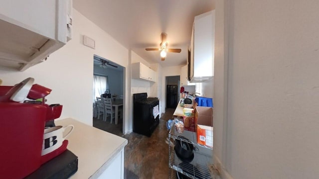 kitchen with white cabinets, black electric range oven, and dark hardwood / wood-style flooring