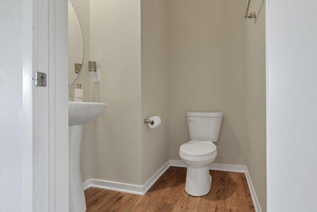 bathroom with toilet and hardwood / wood-style flooring