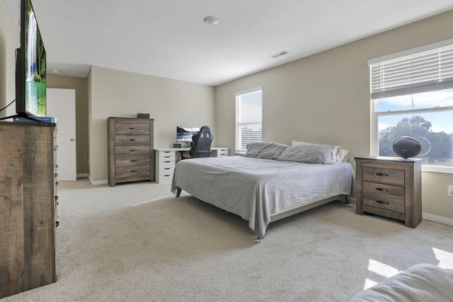 bedroom featuring light colored carpet