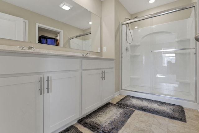 bathroom with vanity and a shower with shower door