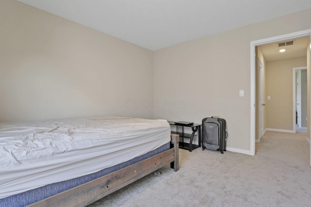 bedroom featuring light carpet