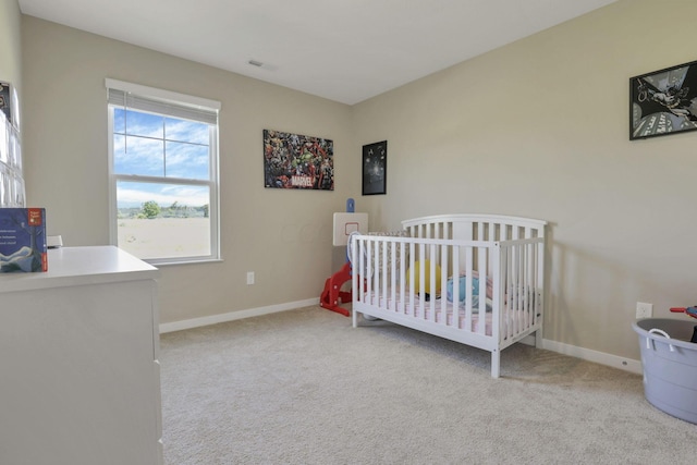 carpeted bedroom with a crib