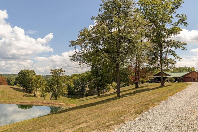 exterior space featuring a lawn and a water view