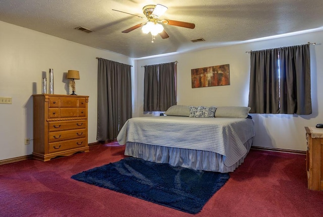 carpeted bedroom featuring a textured ceiling and ceiling fan