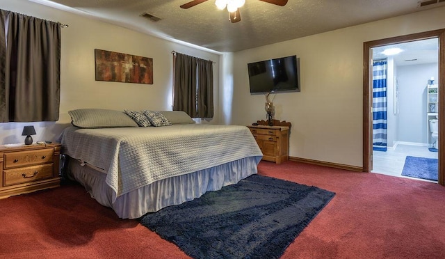 carpeted bedroom with ensuite bathroom, ceiling fan, and a textured ceiling