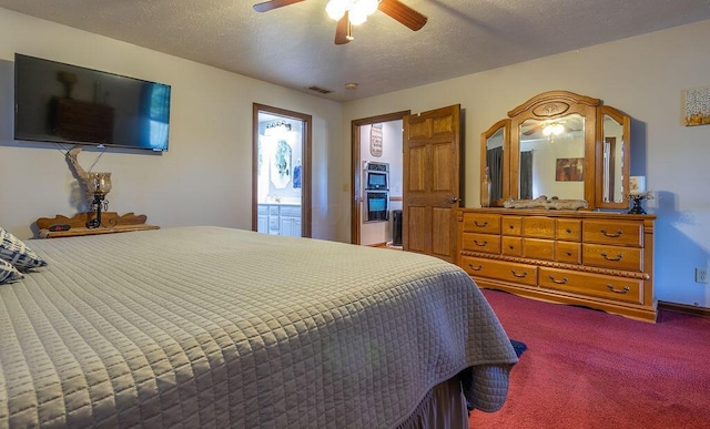 carpeted bedroom featuring a textured ceiling, ceiling fan, and ensuite bathroom