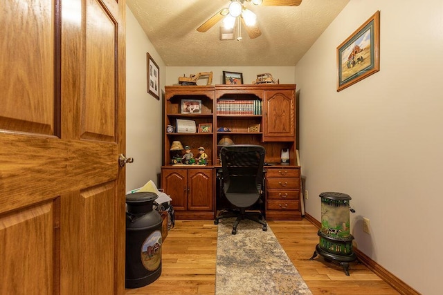 home office featuring ceiling fan, a textured ceiling, and light hardwood / wood-style flooring