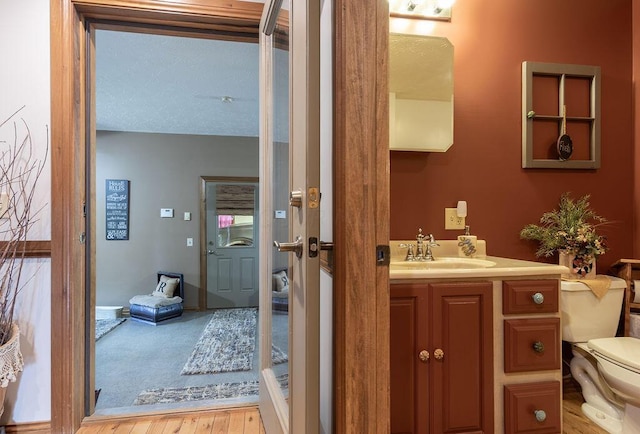 bathroom featuring vanity, toilet, and wood-type flooring