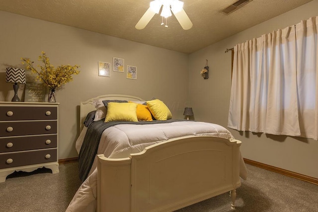 bedroom featuring dark colored carpet, ceiling fan, and a textured ceiling