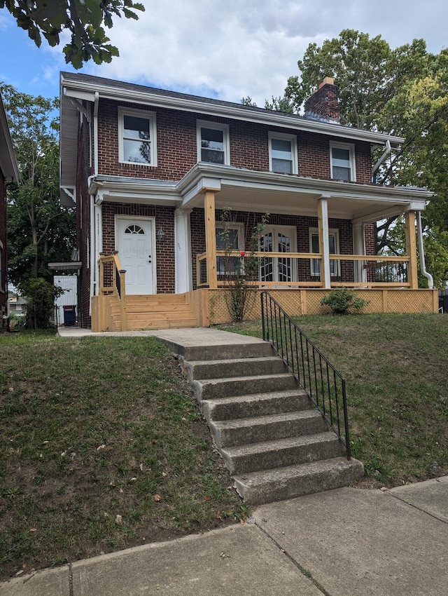 view of front facade with a porch and a front lawn