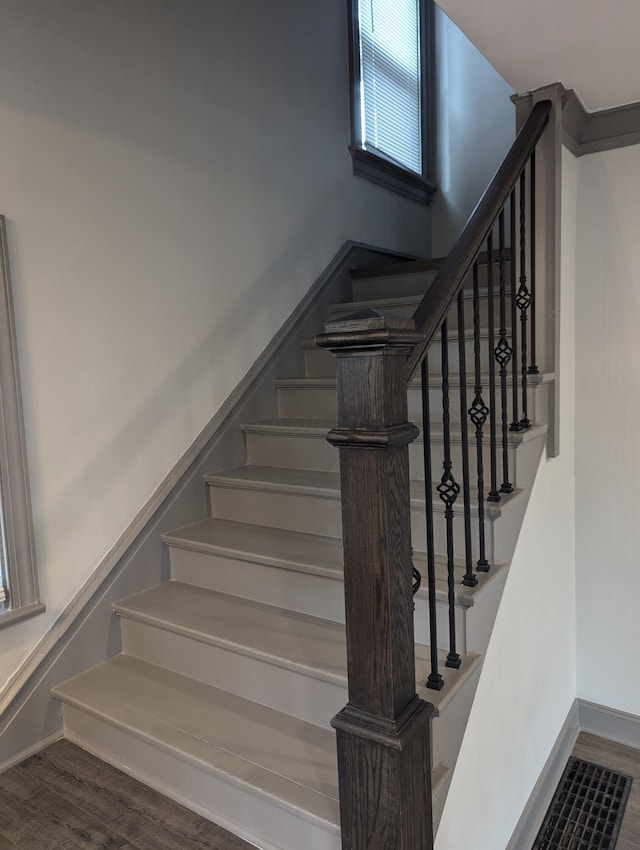 stairway with hardwood / wood-style floors