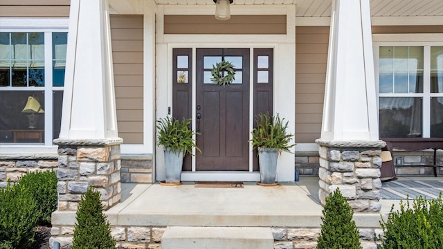 view of exterior entry featuring covered porch