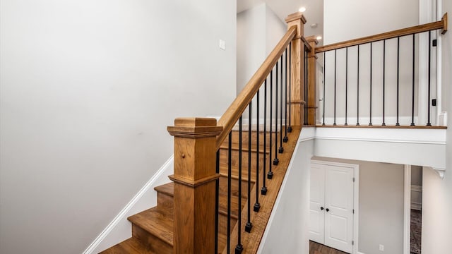 stairway with hardwood / wood-style flooring