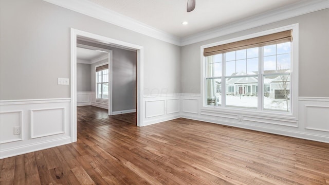 spare room featuring ceiling fan, wood-type flooring, and ornamental molding