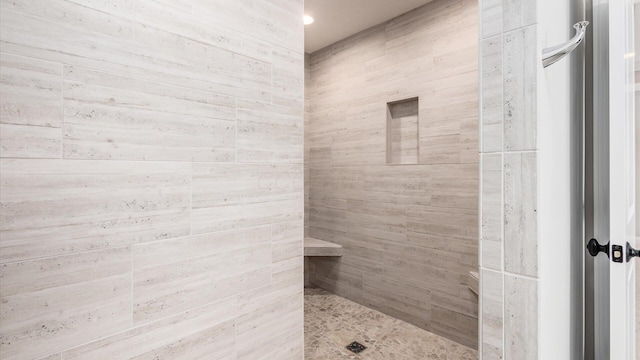 bathroom with tiled shower