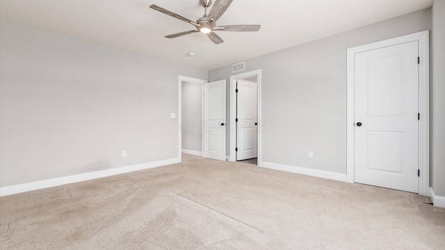 unfurnished bedroom with ceiling fan and light colored carpet