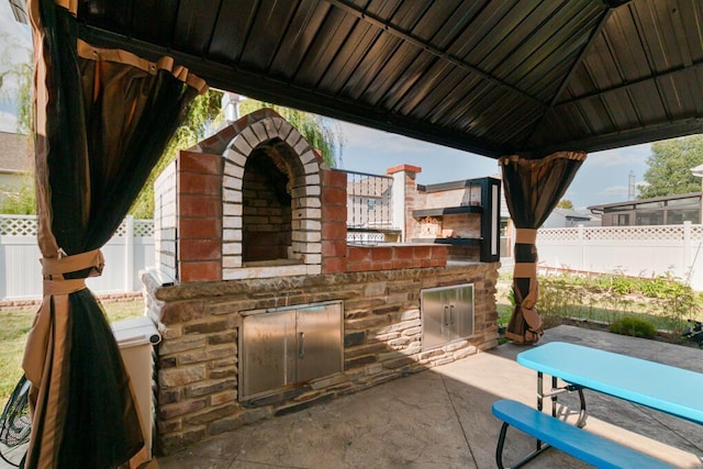 view of patio / terrace featuring a gazebo and area for grilling