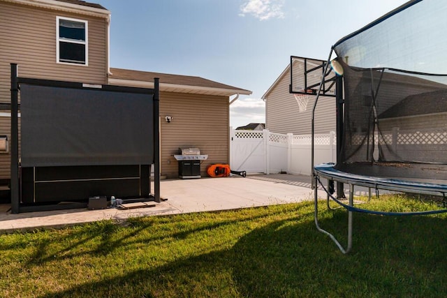 view of yard featuring a patio and a trampoline