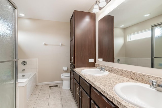 bathroom with vanity, toilet, a bathing tub, and tile patterned flooring