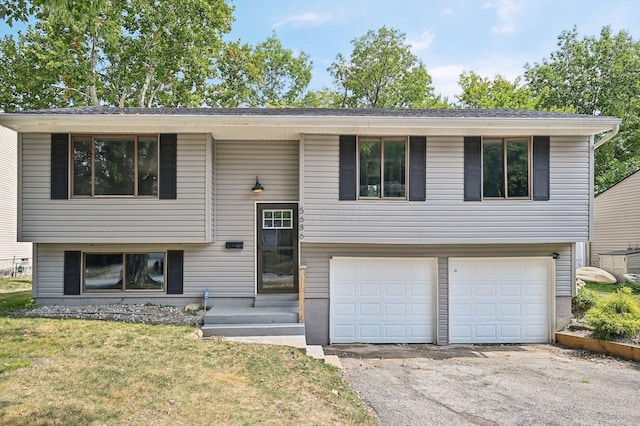 bi-level home featuring a front yard and a garage