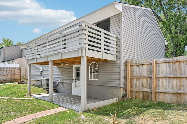 exterior space with a yard and central AC unit