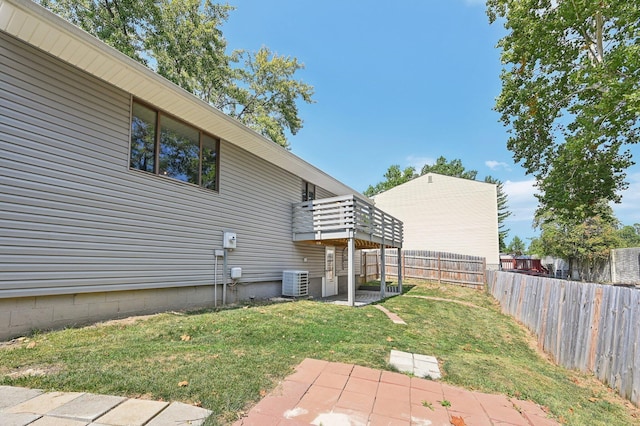 view of yard with a patio, a balcony, and central air condition unit