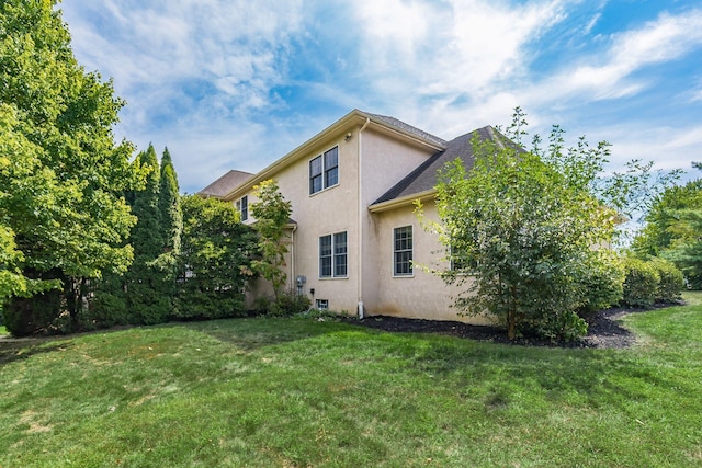 view of side of property with a yard