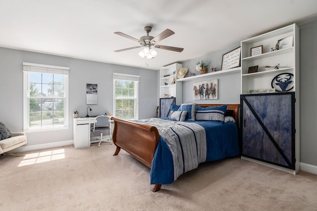 bedroom featuring light colored carpet and ceiling fan