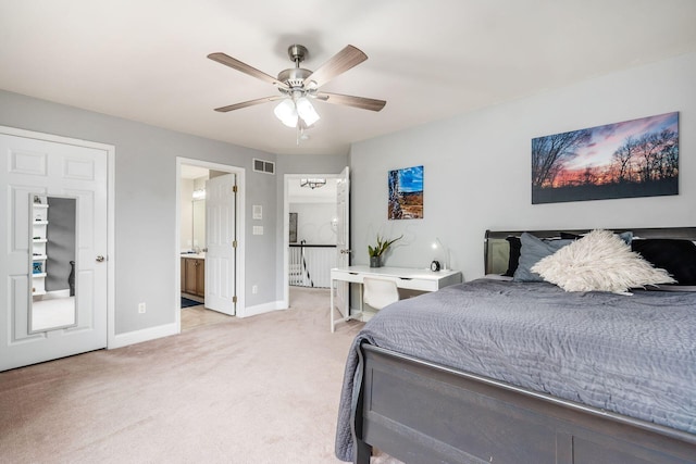 carpeted bedroom featuring ceiling fan and ensuite bathroom