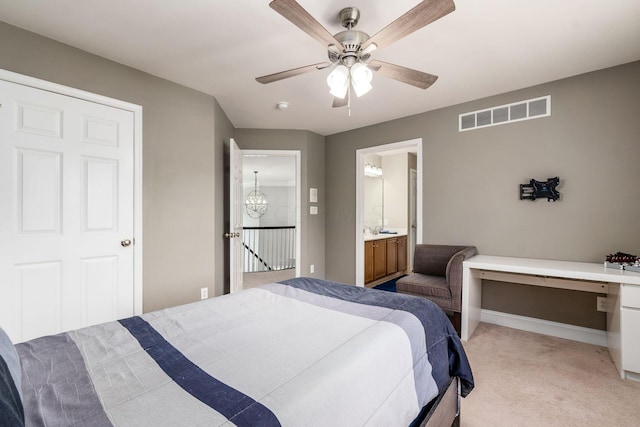 carpeted bedroom featuring ensuite bath and ceiling fan