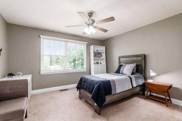 bedroom featuring ceiling fan and light carpet