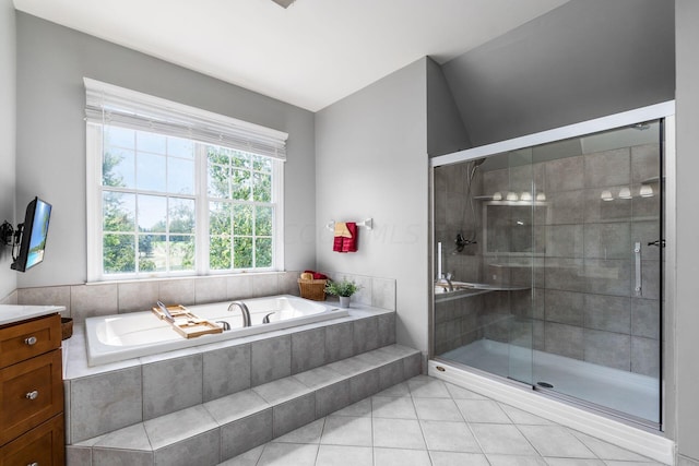 bathroom with tile patterned floors and shower with separate bathtub