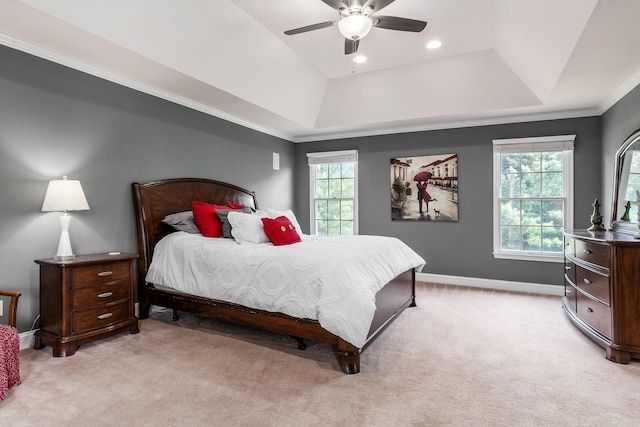 bedroom with multiple windows, ceiling fan, and light colored carpet