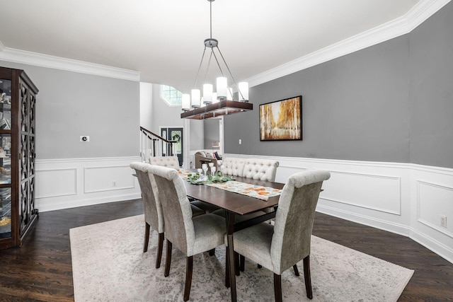 dining space with crown molding, dark hardwood / wood-style flooring, and a chandelier