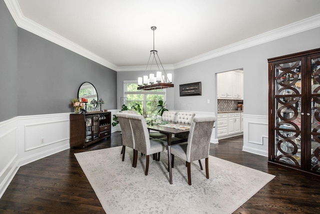 dining room with dark wood-type flooring and ornamental molding