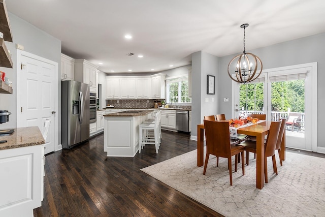 dining room featuring a notable chandelier and dark hardwood / wood-style flooring